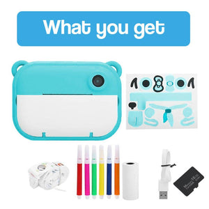 Kids instant print camera with paper roll, colored markers, USB cable, and memory card accessories in blue color