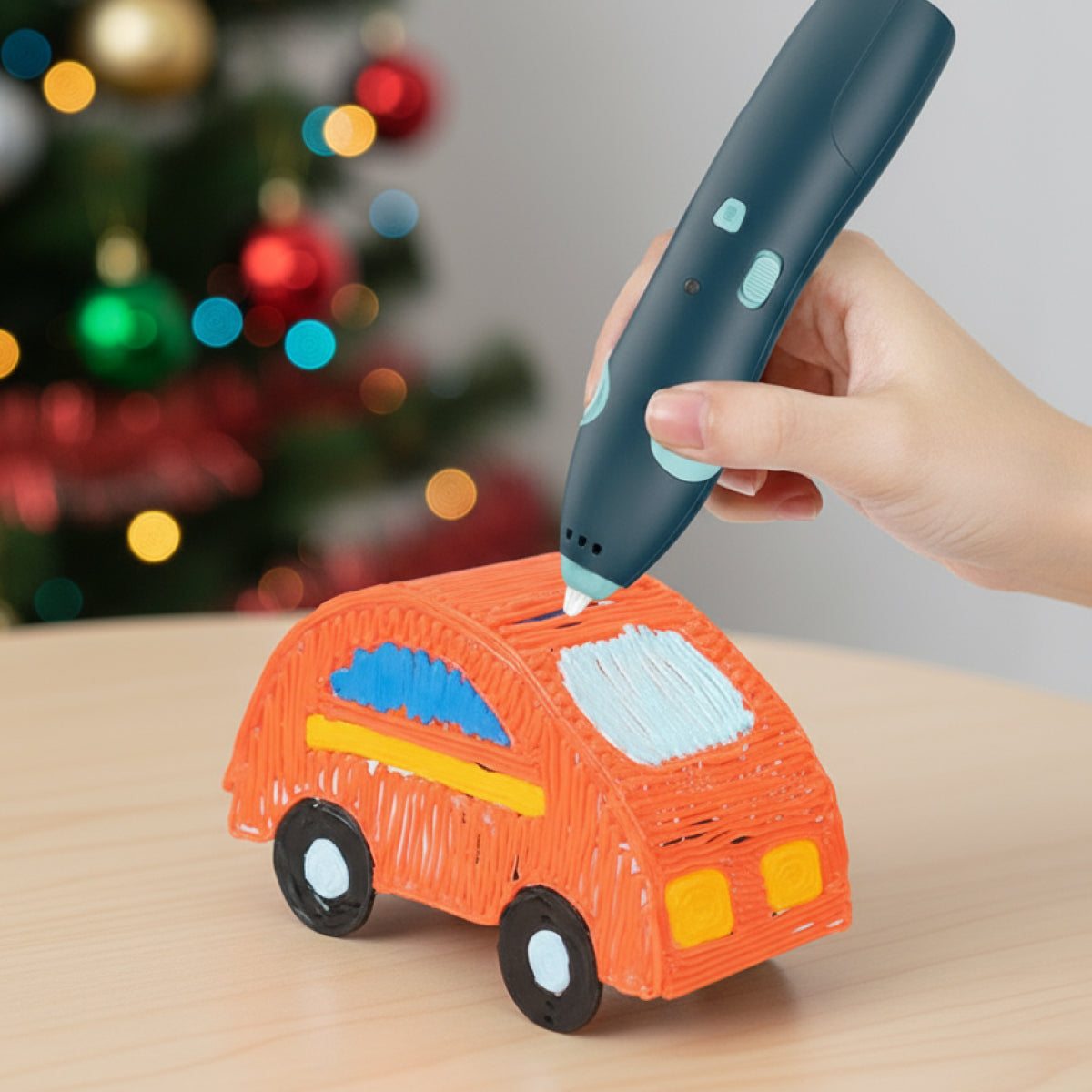 Child using 3D Magic Pen Set to create colorful 3D car sculpture near Christmas decorations