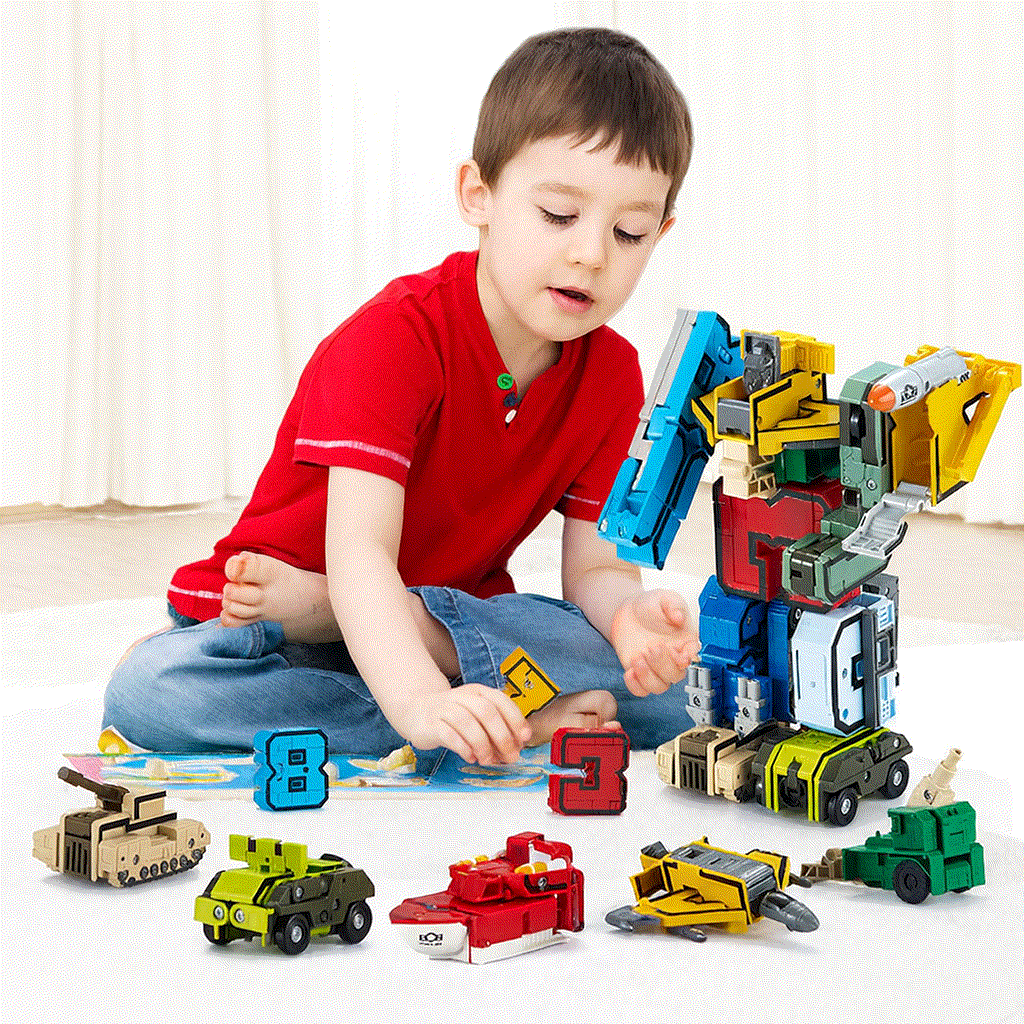 Child playing with digital deformation transforming robot toy and building blocks set